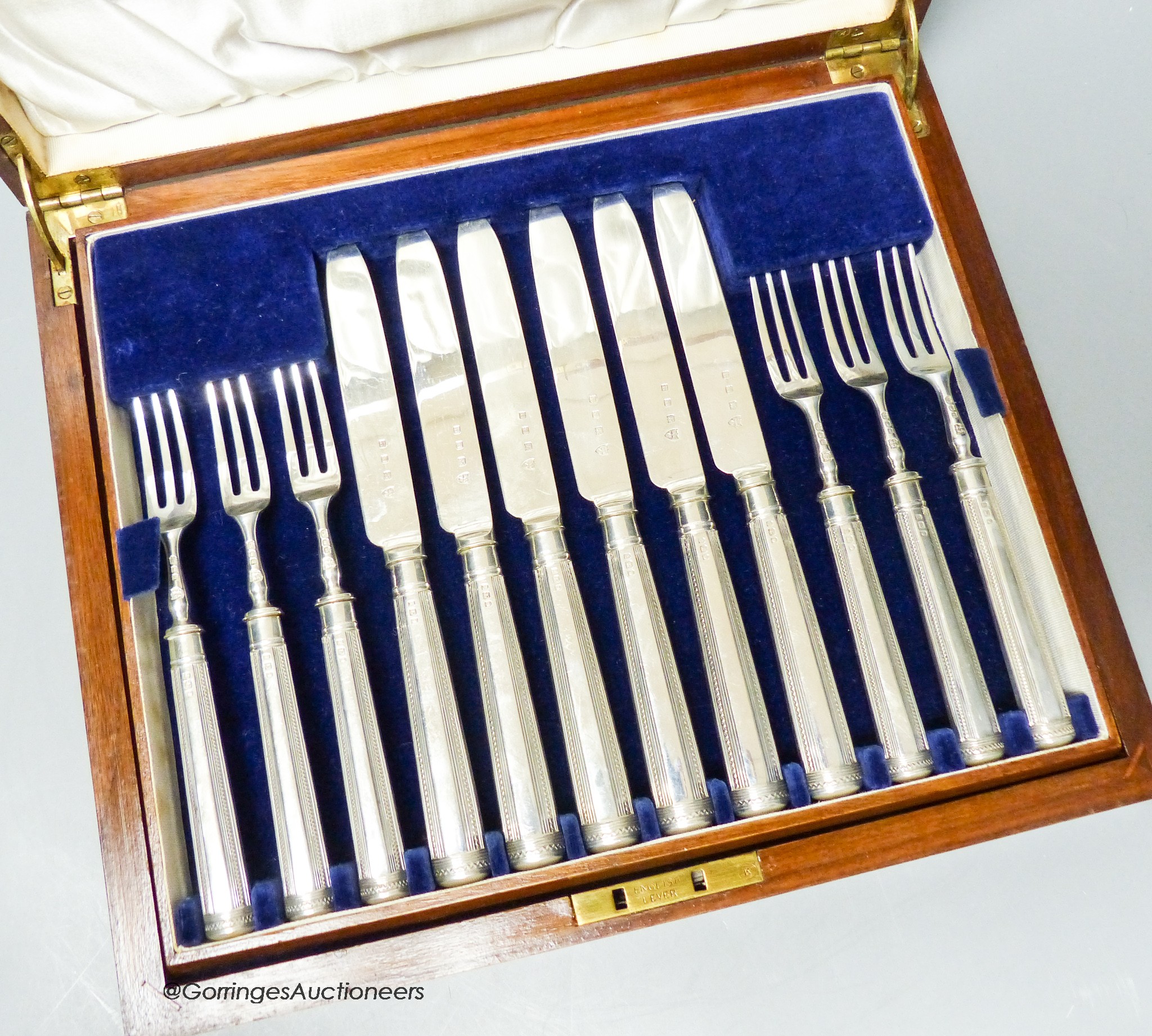 A cased set of twelve pairs of George V silver bladed fruit eaters (weighted handles), Tessiers Ltd, London, 1934.